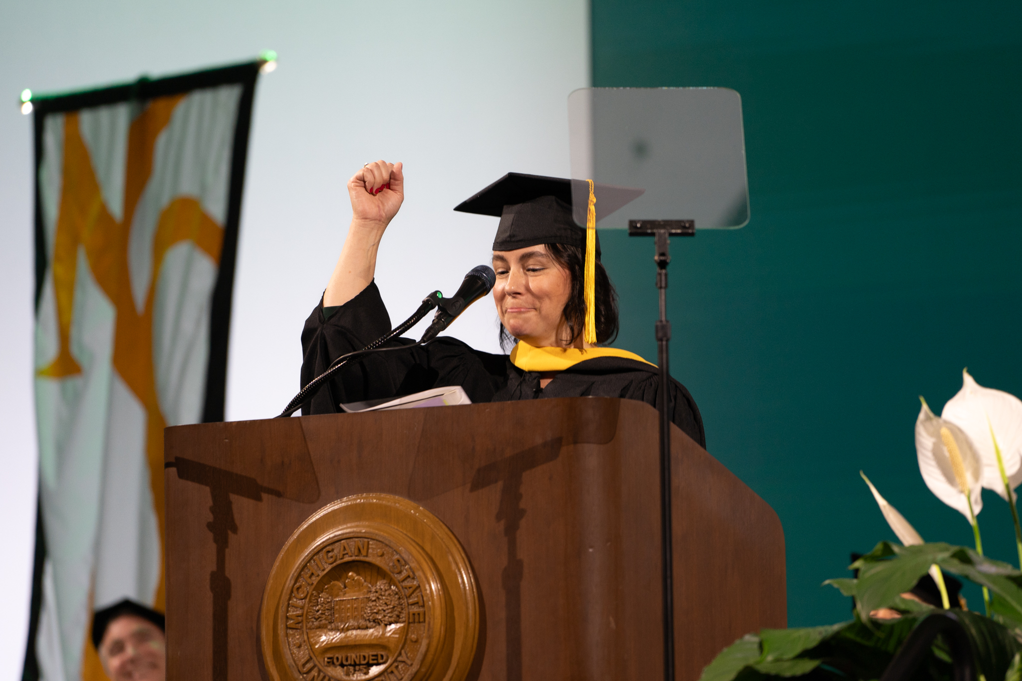 Martin yells 'go green' during the College of Natural Science commencement
