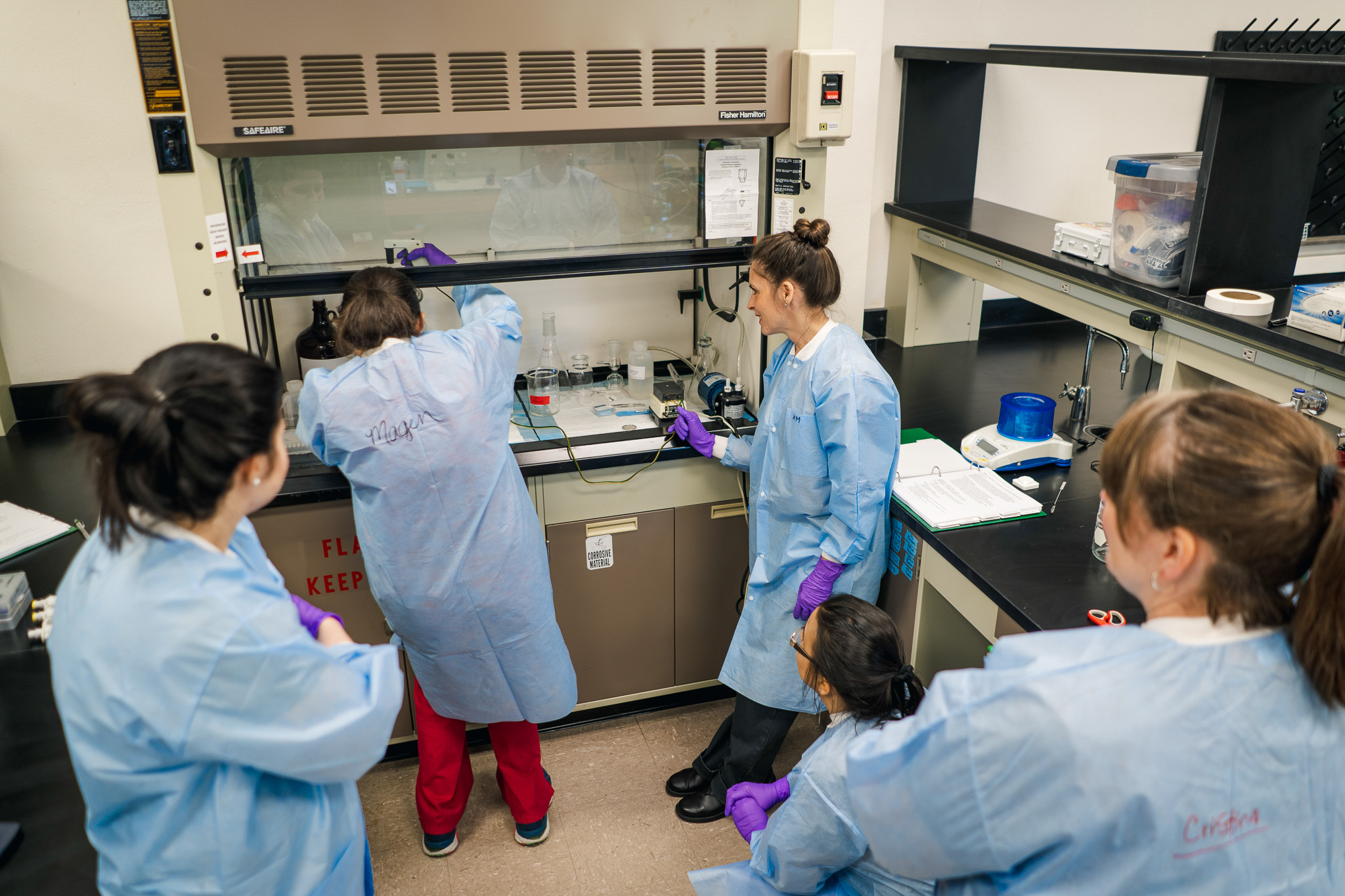 Graduate students pefroming a experiment in the lab.